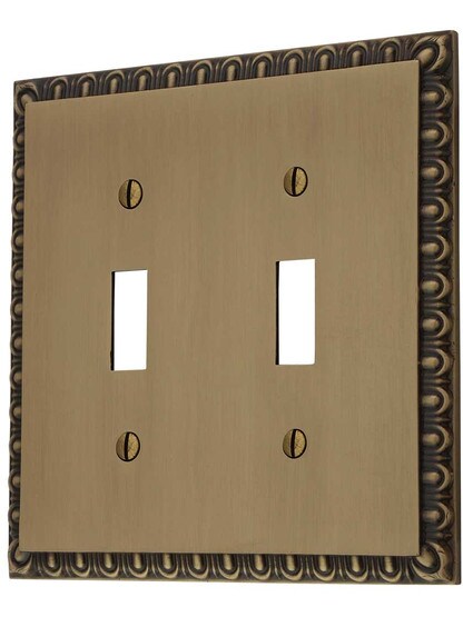 Ovolo Double Gang Toggle Switch Plate in Antique Brass.